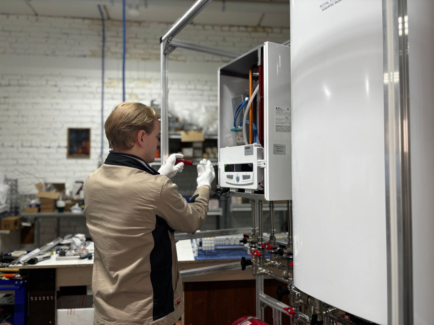HVAC technician working on heating system in workshop