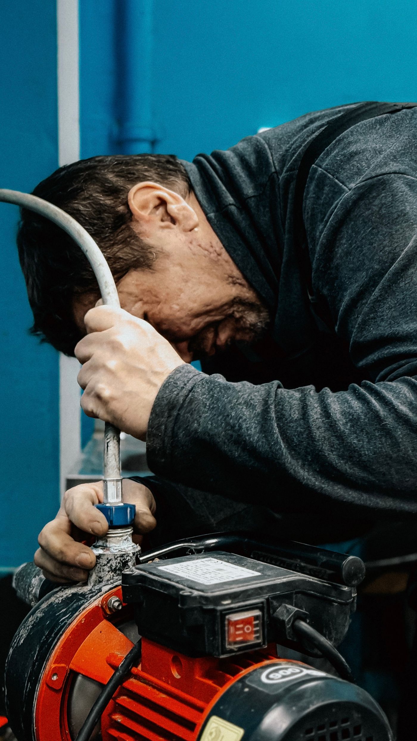 Technician adjusting water pump system with precision