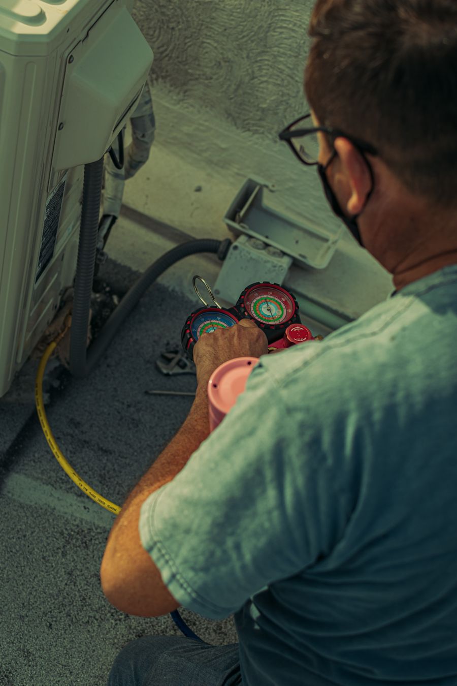 HVAC technician repairing an outdoor unit